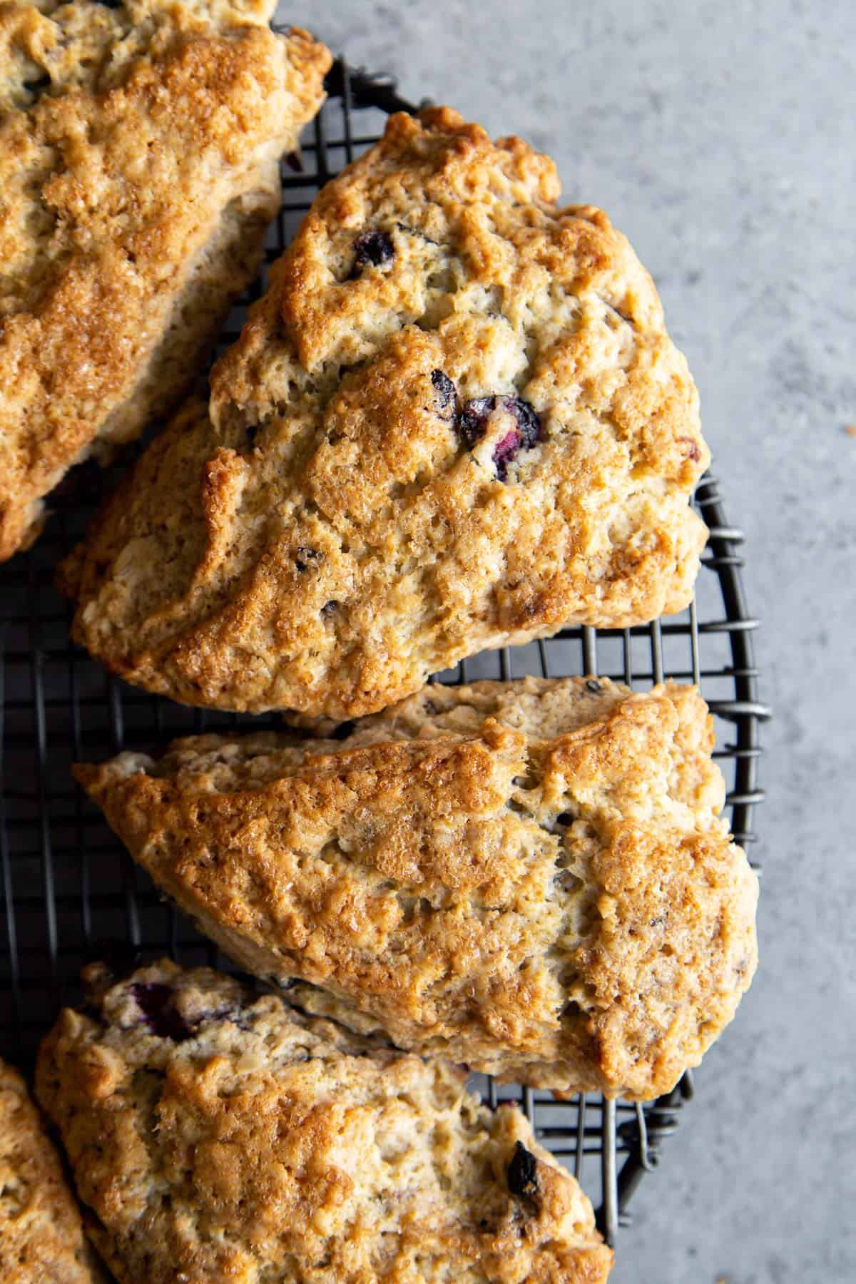 lemon blueberry scones on black wire rack. 