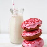 Valentine Cake Doughnuts dipped in pink glaze and topped with red sprinkles