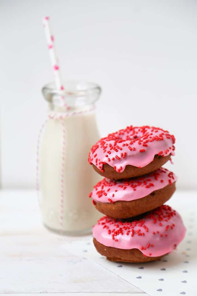 Valentine Cake Doughnuts dipped in pink glaze and topped with red sprinkles