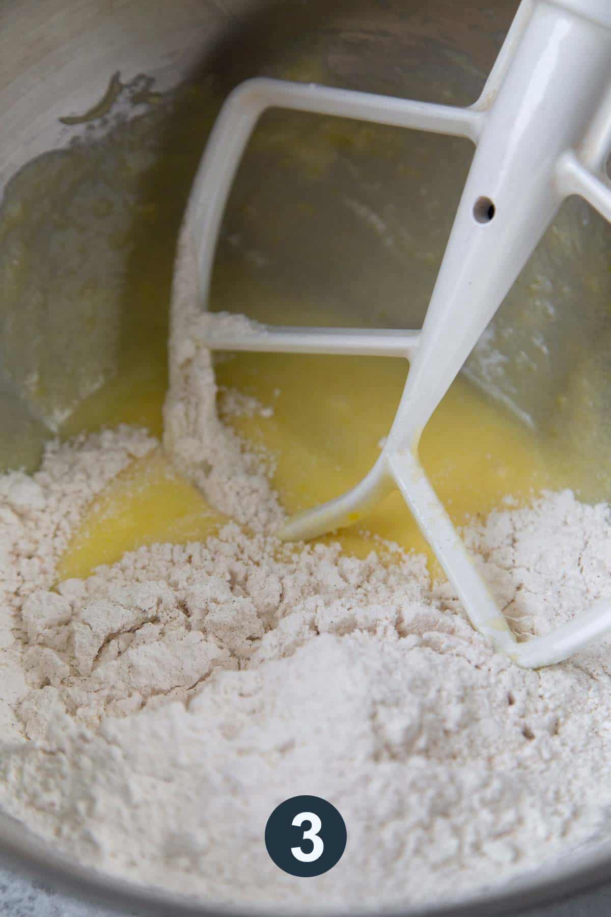 flour mixture added to creamed sugar egg mixture in mixture bowl with paddle attachment.