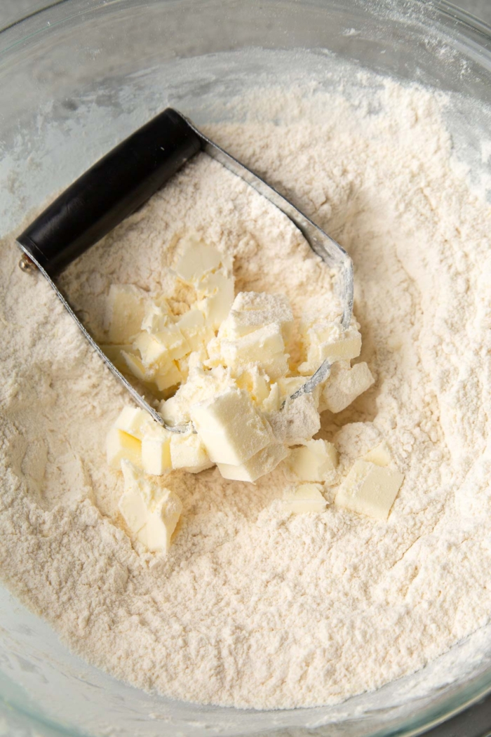 cut cold butter cubes into dry mixture.