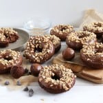 landscape shot of double chocolate cake donuts topped with chopped peanuts