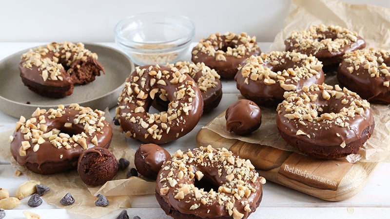 landscape shot of double chocolate cake donuts topped with chopped peanuts