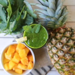 green smoothie featuring mango, pineapple, and baby kale