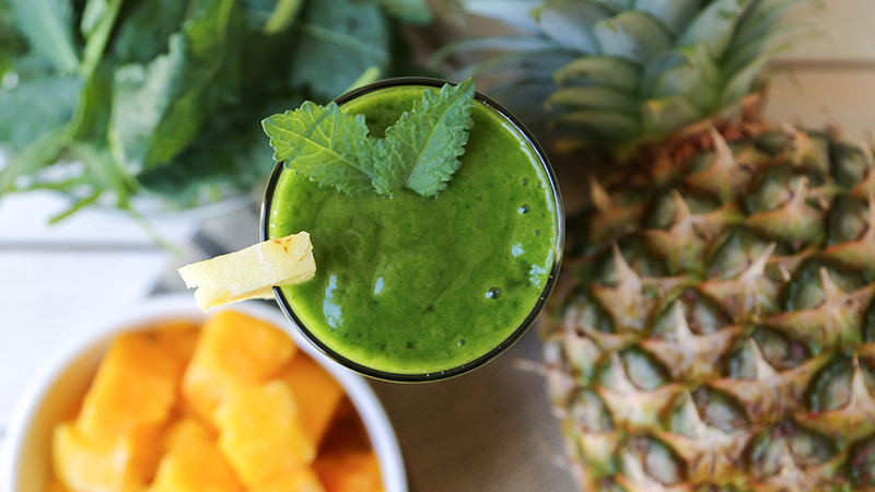 green smoothie featuring mango, pineapple, and baby kale