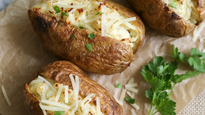 three pieces of twice baked ranch potatoes on marble slab.