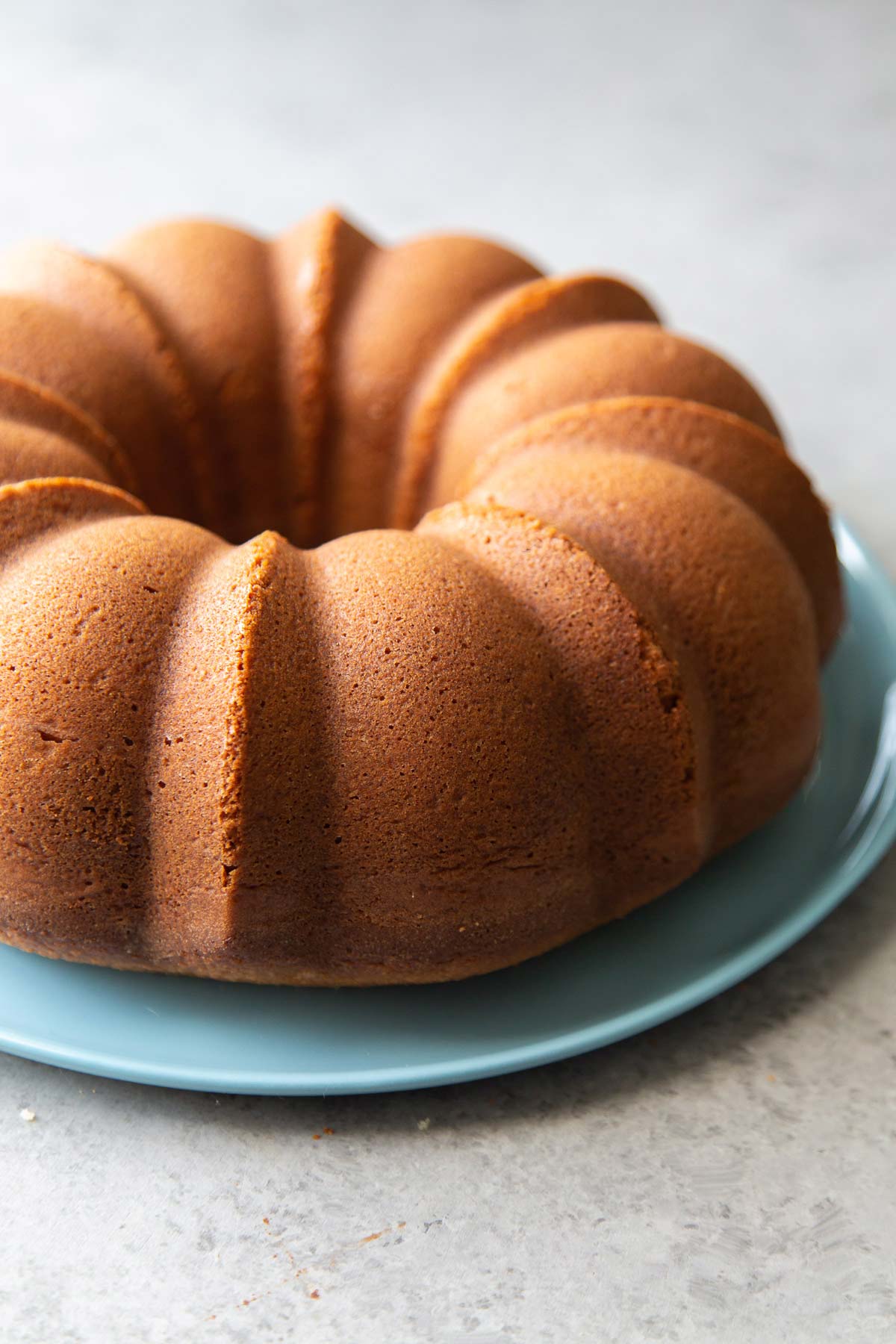 almond flour pound cake on blue serving plate.