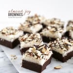 almond joy brownies arranged on parchment paper.