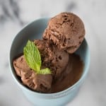 three scoops dark chocolate mint ice cream in a bowl serving bowl.