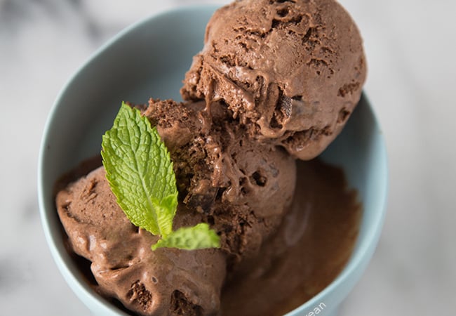 three scoops dark chocolate mint ice cream in a bowl serving bowl.