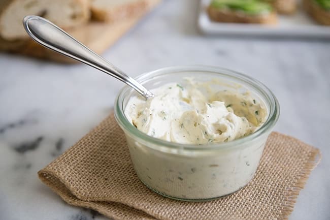 Garlic and Chives Cream Cheese Spread in glass container.