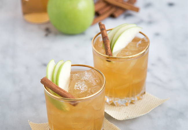 Apple Pie Moonshine Cocktail garnished with cinnamon stick.