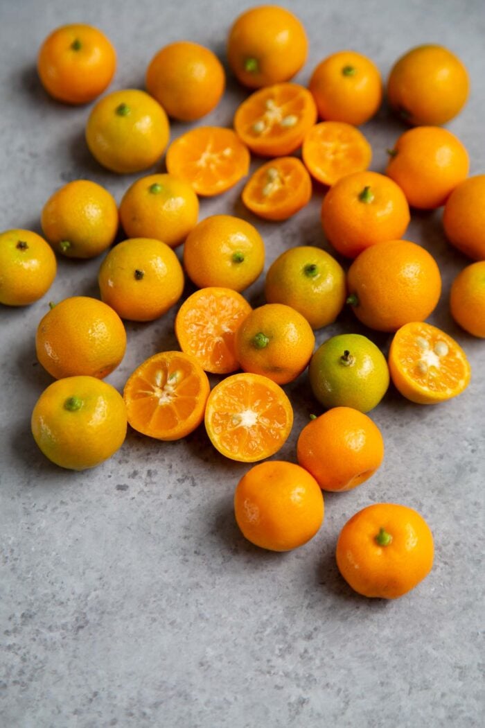 ripe calamansi fruit on gray surface.