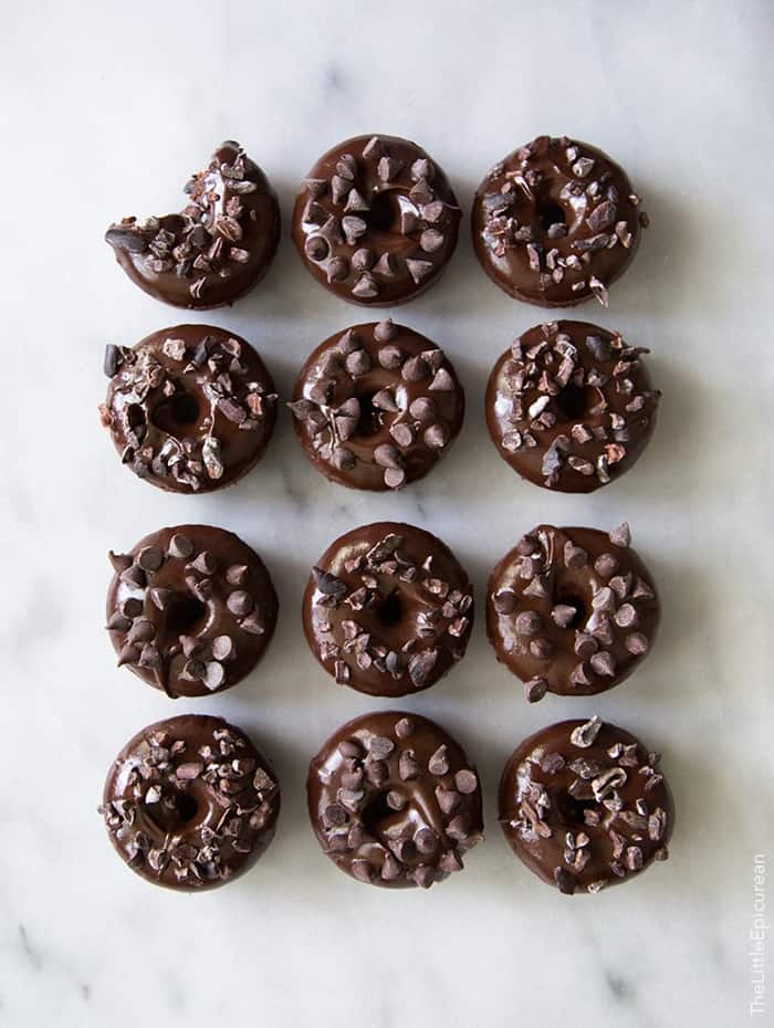 Triple Chocolate Baked Donuts. Baked chocolate donuts dipped in chocolate glaze topped with mini chocolate chip and cacao nibs.