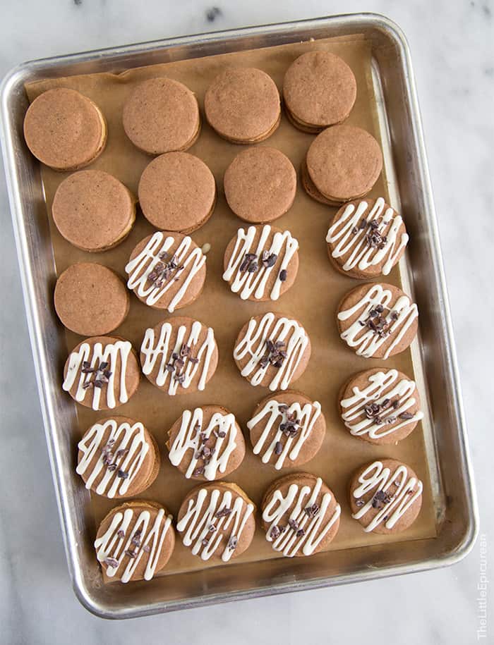 assembled peanut butter espresso cookie sandwiches on baking sheet. 