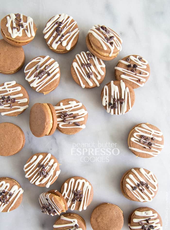 peanut butter espresso cookie sandwiches arranged on marble table. 