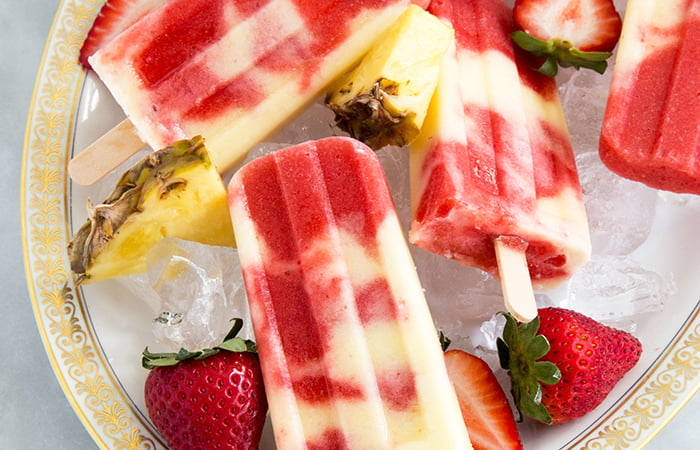 Lava Flow Popsicles made with coconut, pineapple, and strawberry