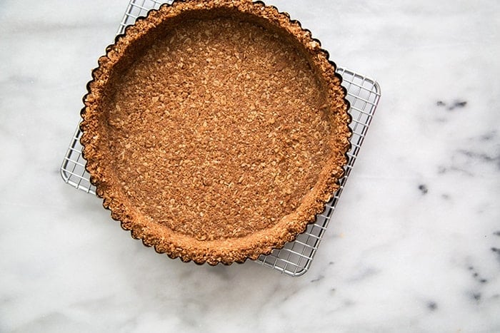 oatmeal graham cracker tart shell crust on wire rack. 