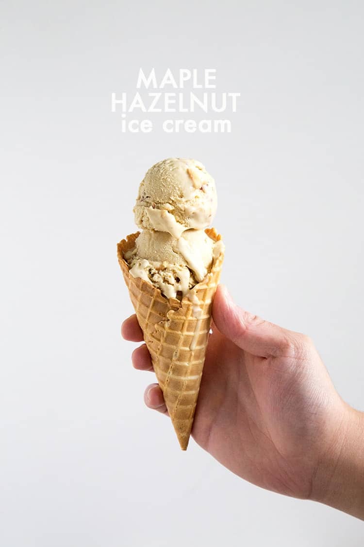 two scoops of maple hazelnut ice cream in a waffle cone. 
