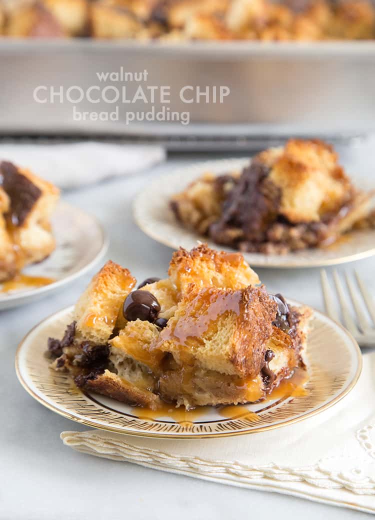 serving of walnut chocolate chip bread pudding with caramel sauce on dessert plate.