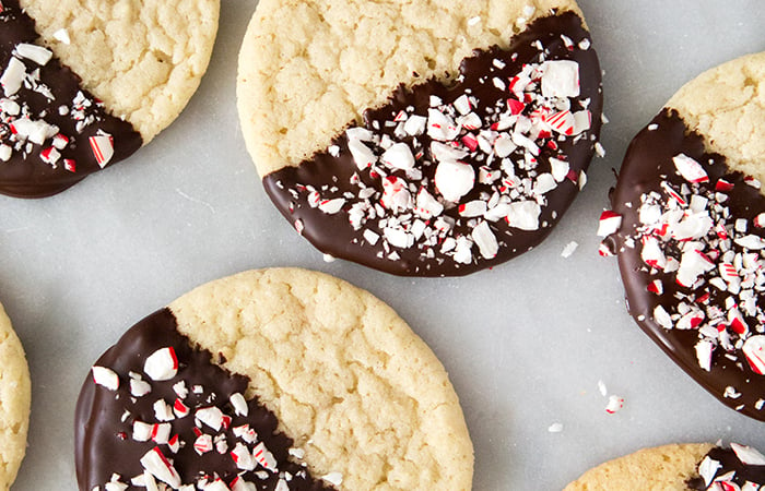 Peppermint Chocolate Dipped Sugar Cookies topped with crushed candy canes.