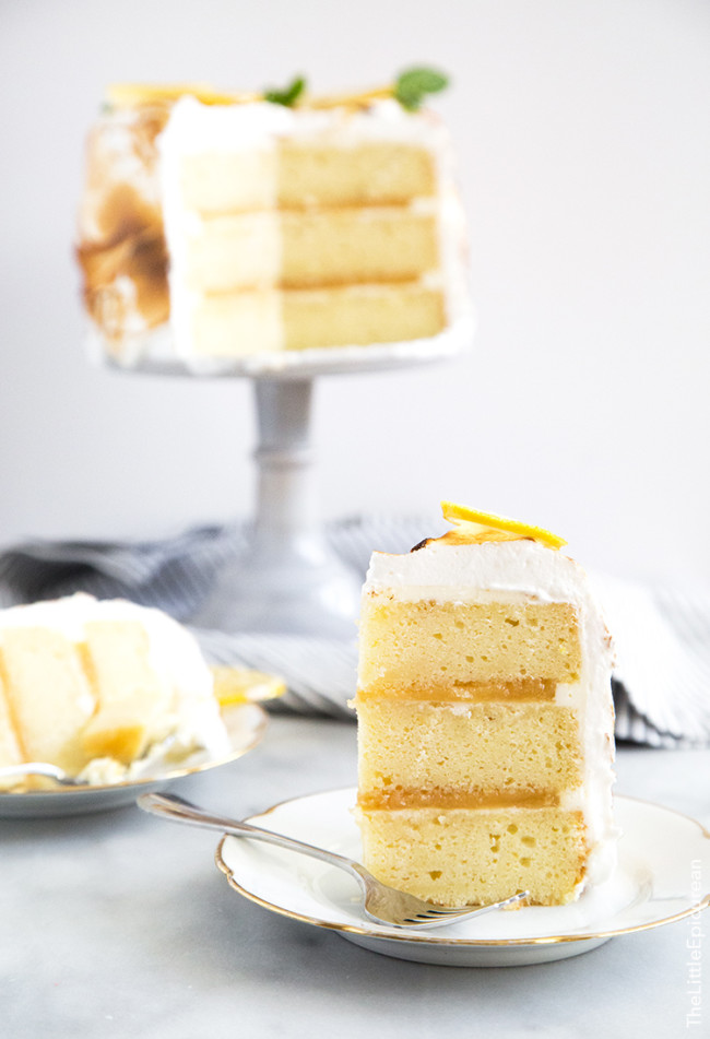 slice of lemon meringue cake with lemon curd filling.