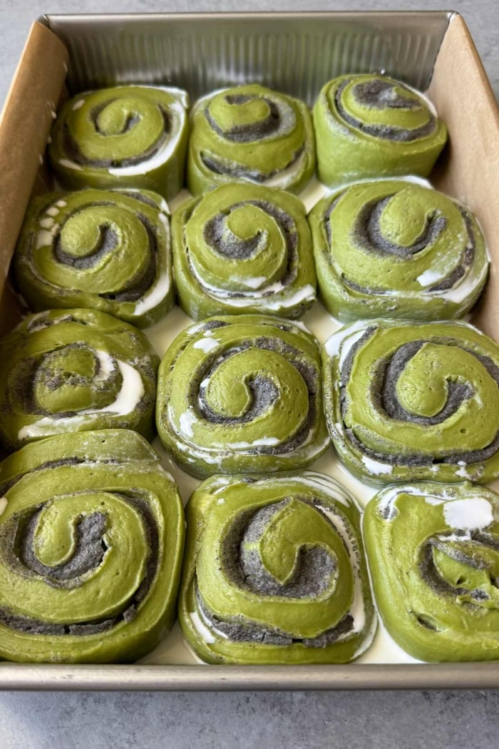 pour cream over risen matcha rolls.