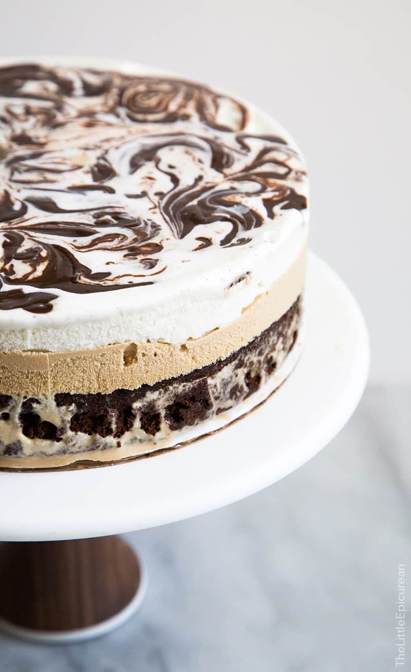 This coffee ice cream cake has a decadent brownie bottom topped with coffee ice cream and a layer of vanilla ice cream swirled with fudge. This ice cream cake takes me back to childhood! 