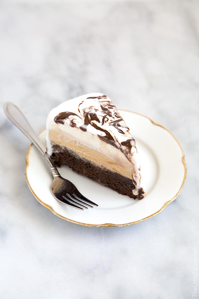 Slice of Coffee Ice Cream Cake. This coffee ice cream cake has a decadent brownie bottom topped with coffee ice cream and a layer of vanilla ice cream swirled with fudge.  