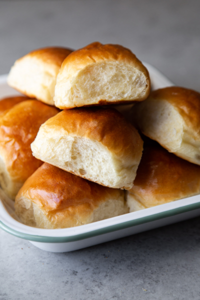 Milk bread dinner rolls stacked in serving platter.