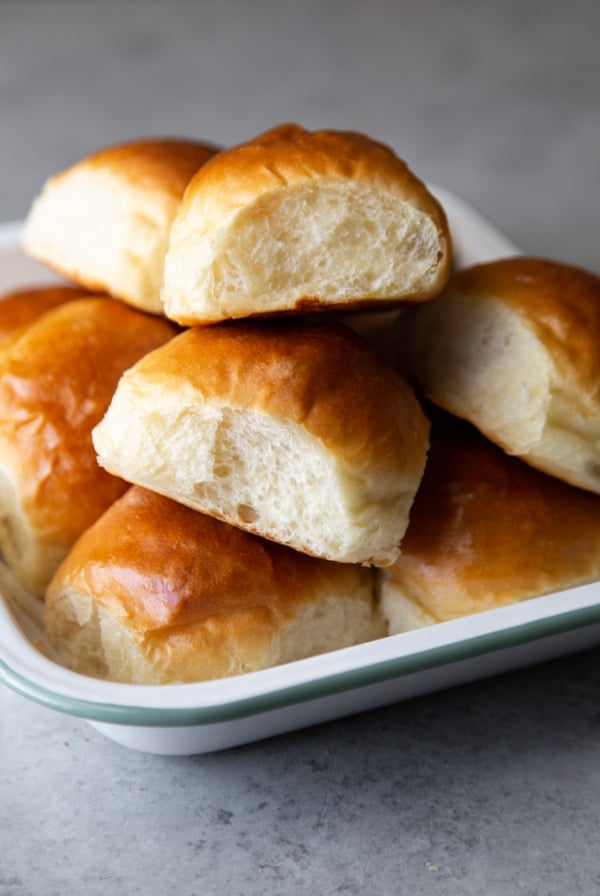 Milk bread dinner rolls stacked in serving platter.