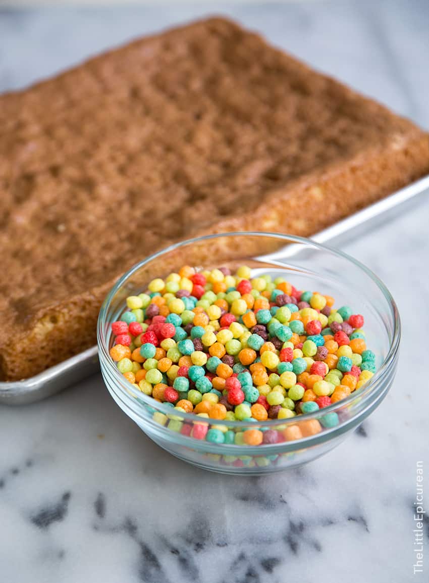 bowl of colorful cereal and baked sponge cake.