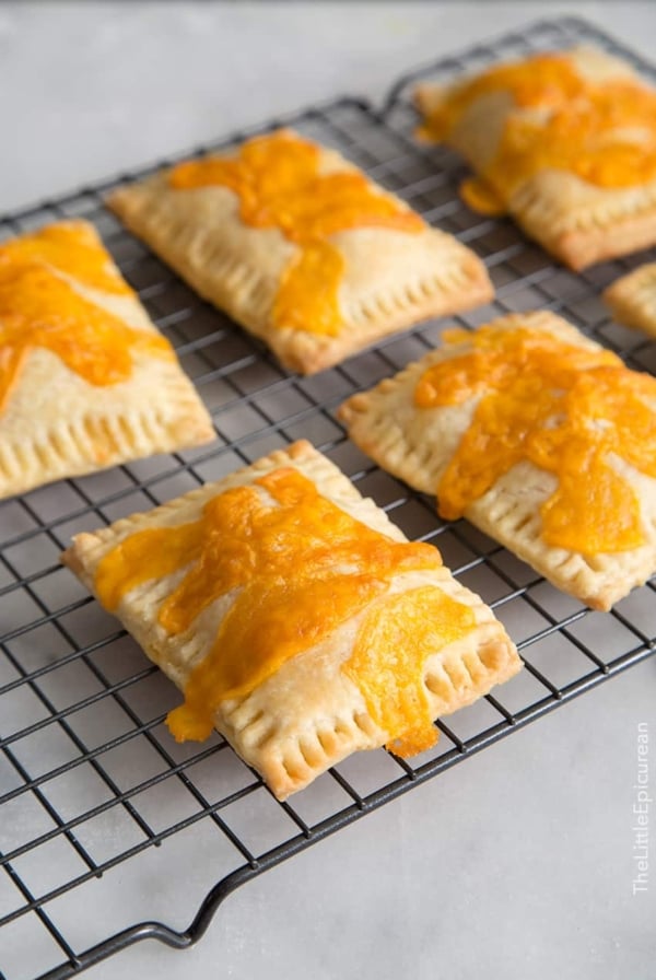 Ham and Cheese Breakfast Tarts on black cooling rack.