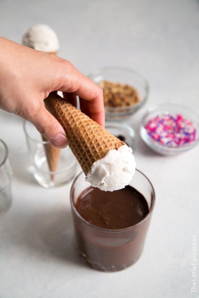 dip coconut ice cream cones int melted chocolate.