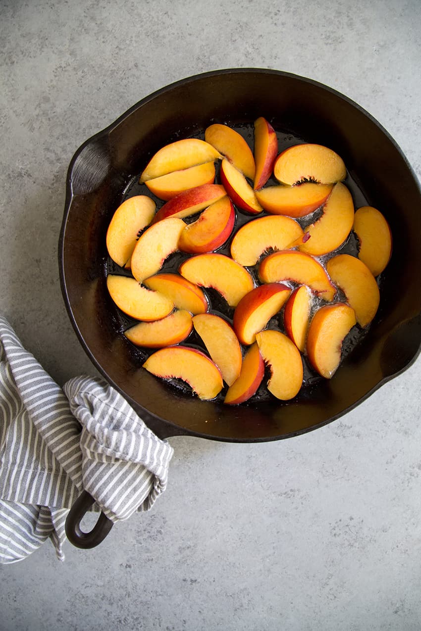 peach slices in cast iron skillet.