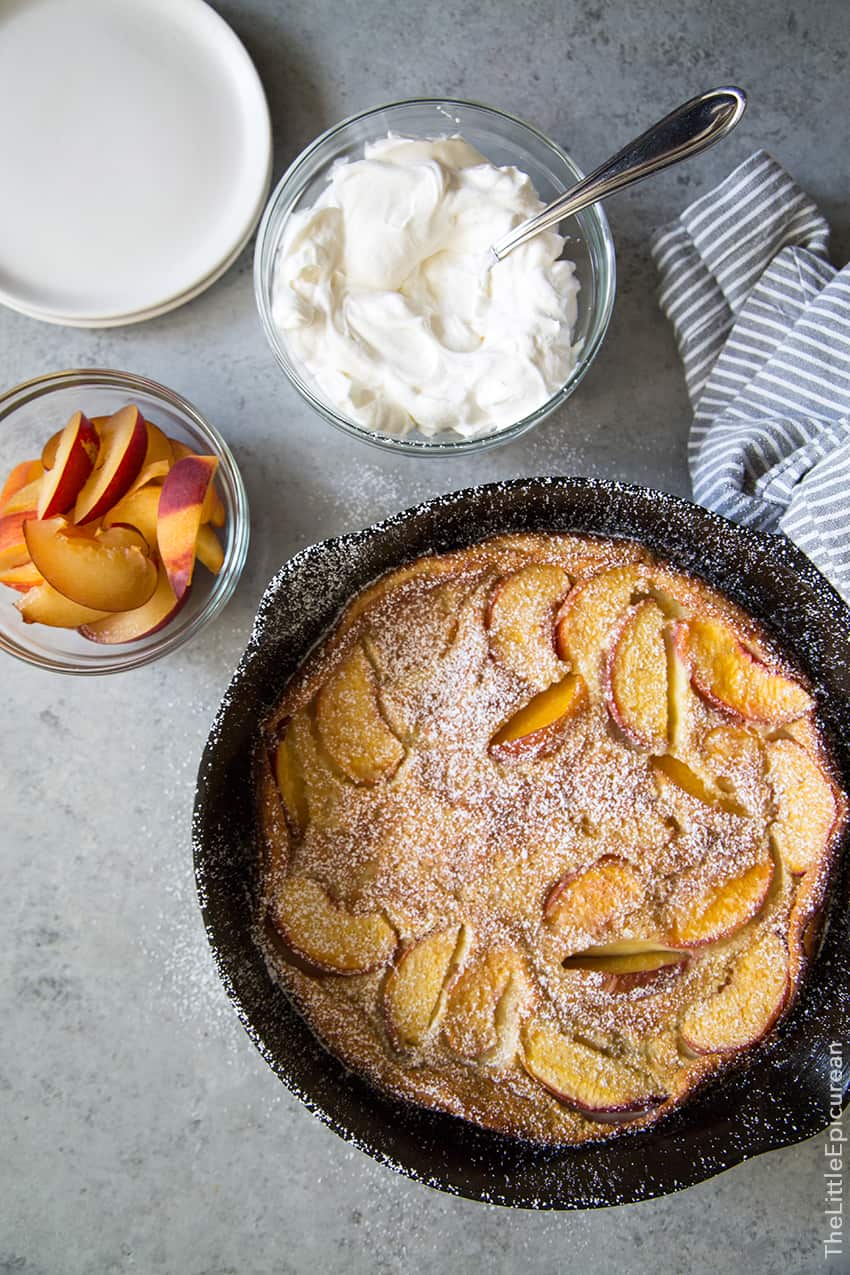 Whiskey Peach Clafoutis baked in cast iron skillet.