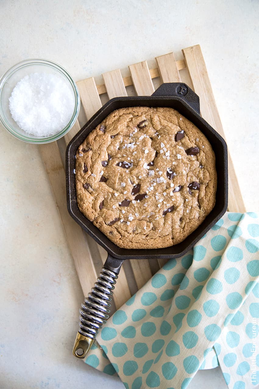 peanut butter chocolate chunk cookie cooked in a skillet topped with maldon sea salt flakes.