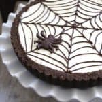 Spider Web Cheesecake Tart on fluted white platter.