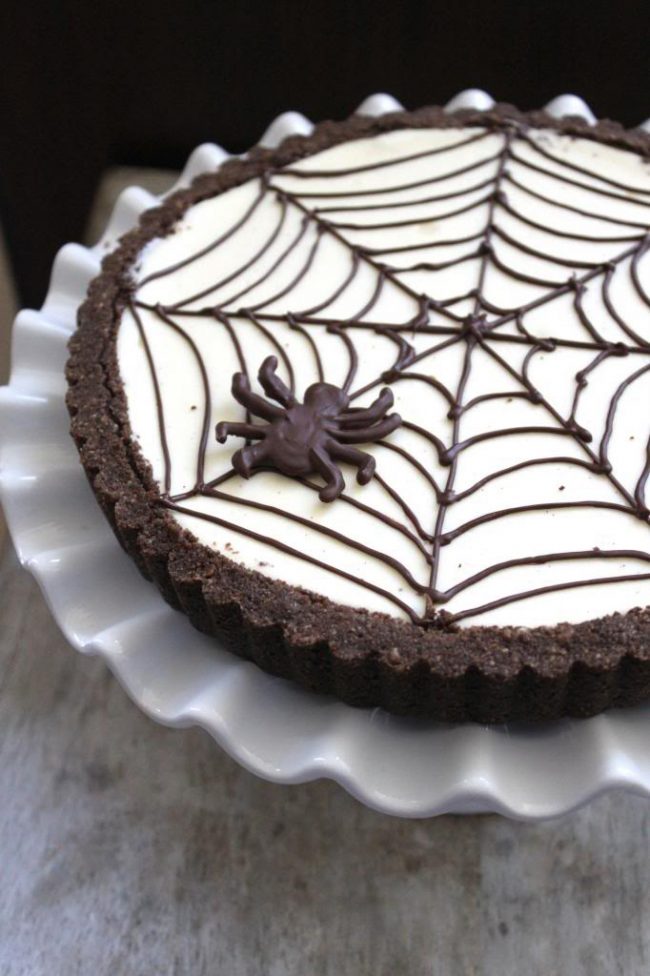 Spider Web Cheesecake Tart on fluted white platter.