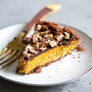 slice of Chocolate Hazelnut Pumpkin Pie on white plate.