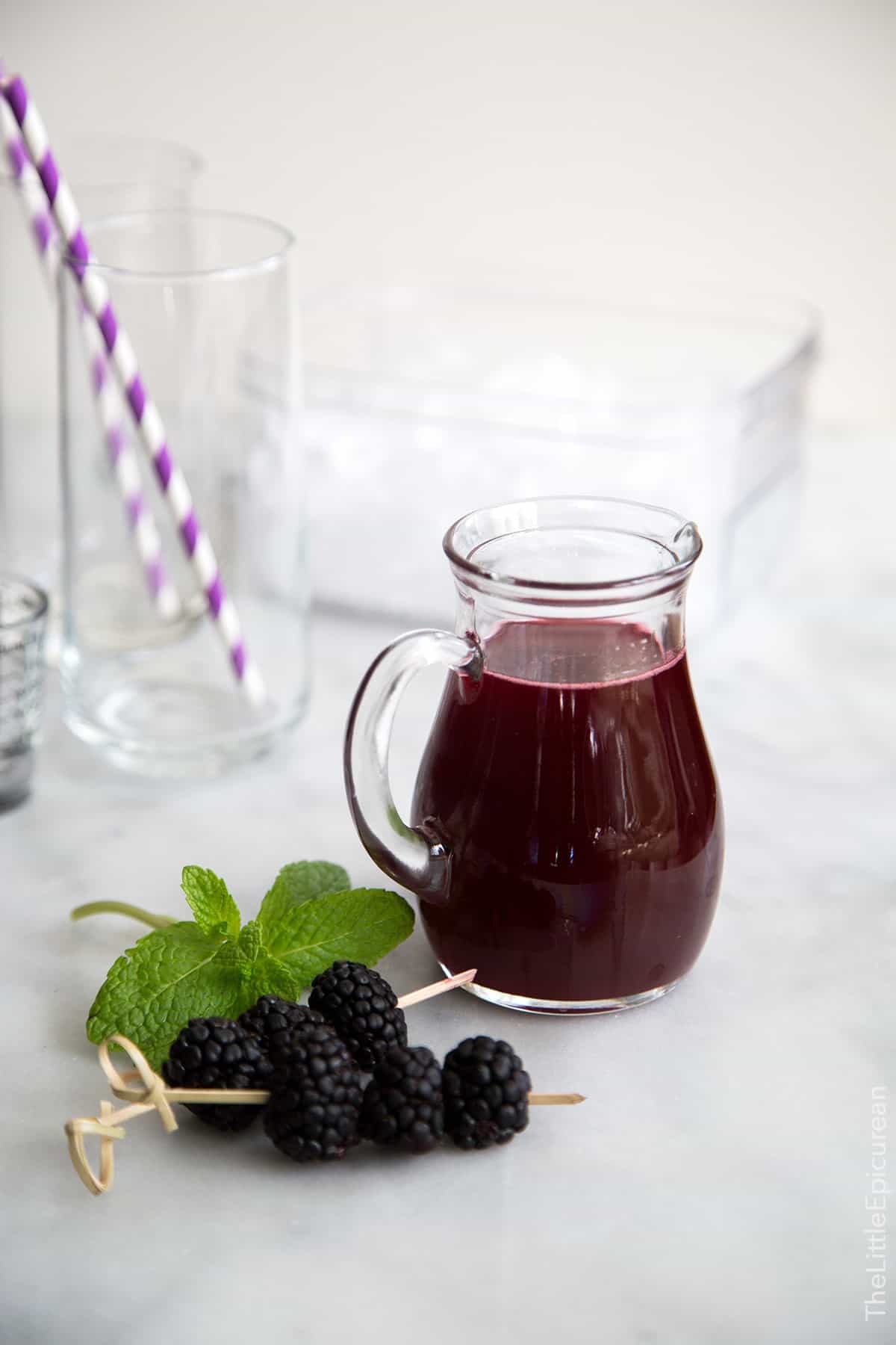 vibrant colorful blackberry shrub in a serving pitcher. 