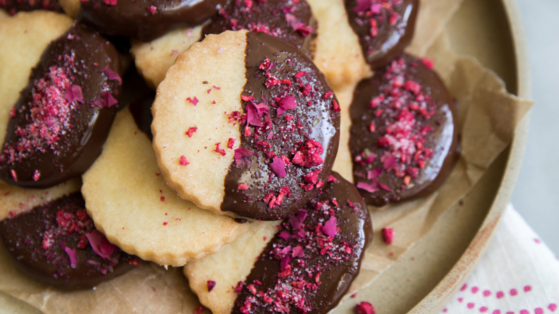 Rose Water Shortbread Cookies on beige plate.