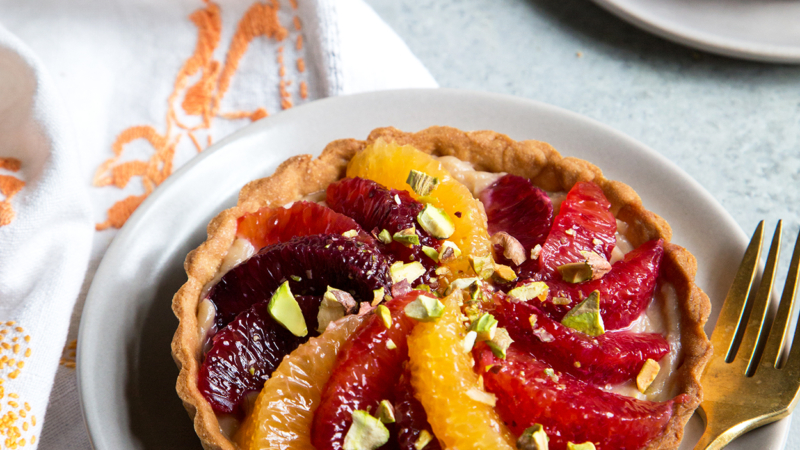 Blood Orange Earl Grey Tarts on serving plate with gold dessert fork.