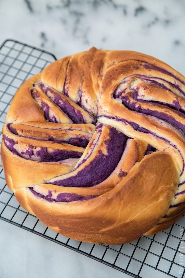 ube swirl bread on wire cooling rack.