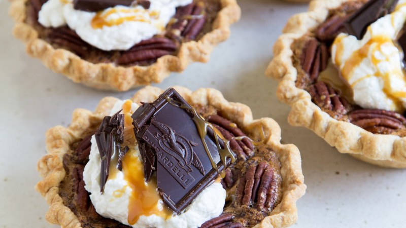 Mini Bourbon Caramel Derby Pies on serving platter.