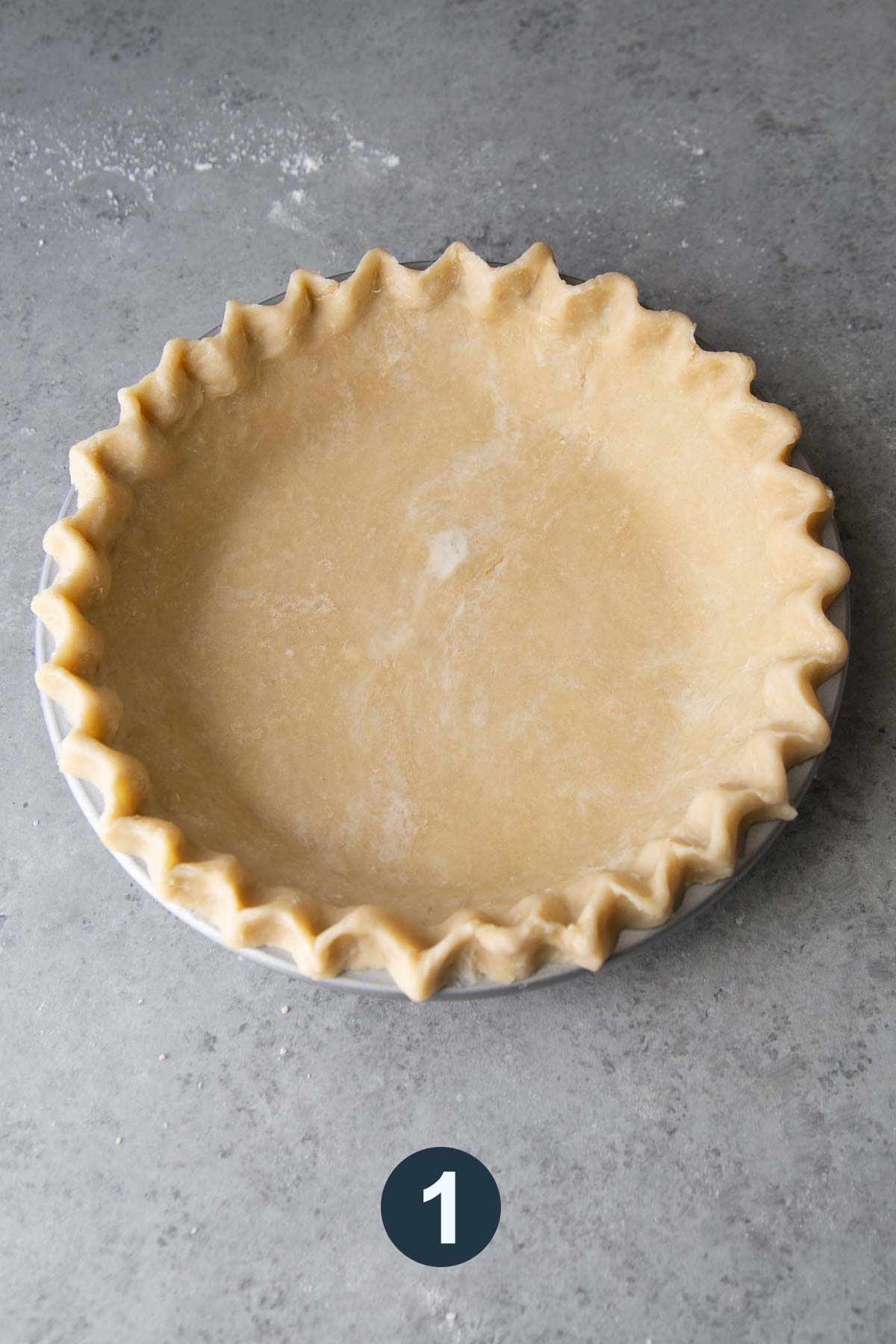 all butter pie dough with crimped edges before baking.