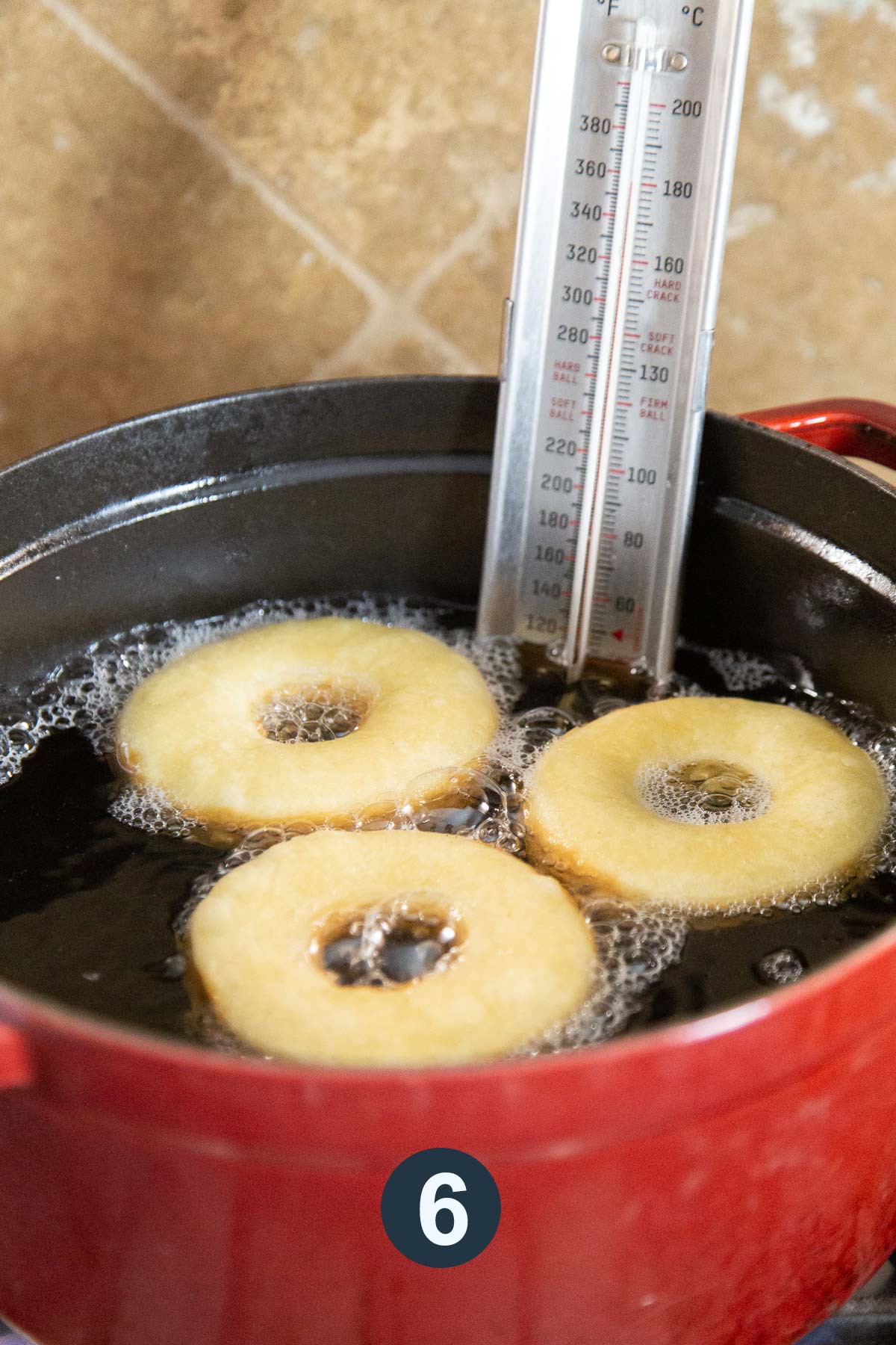 fry three doughnuts at time in hot oil maintained with thermometer.
