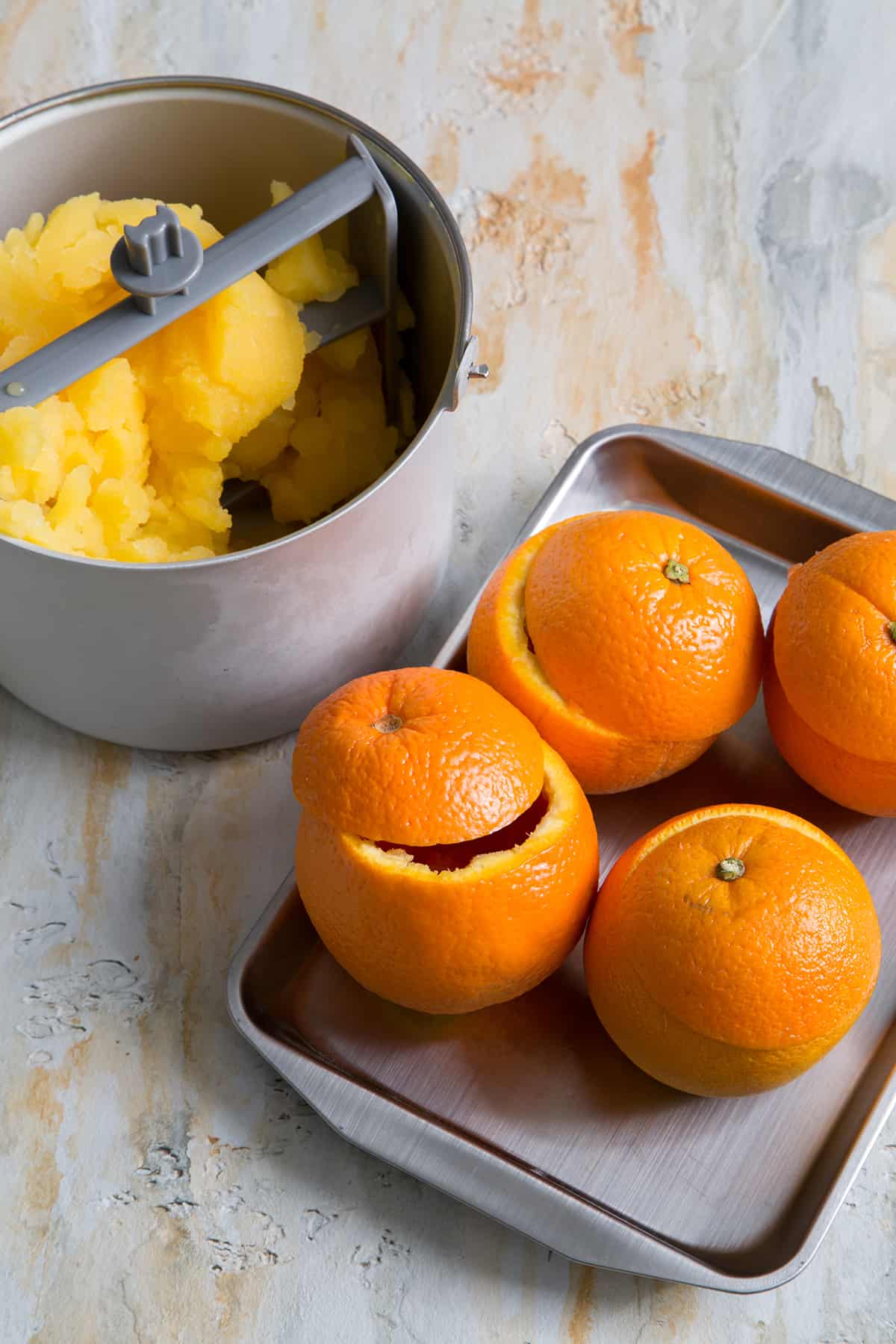 hallowed out oranges to be filled with orange sorbet.