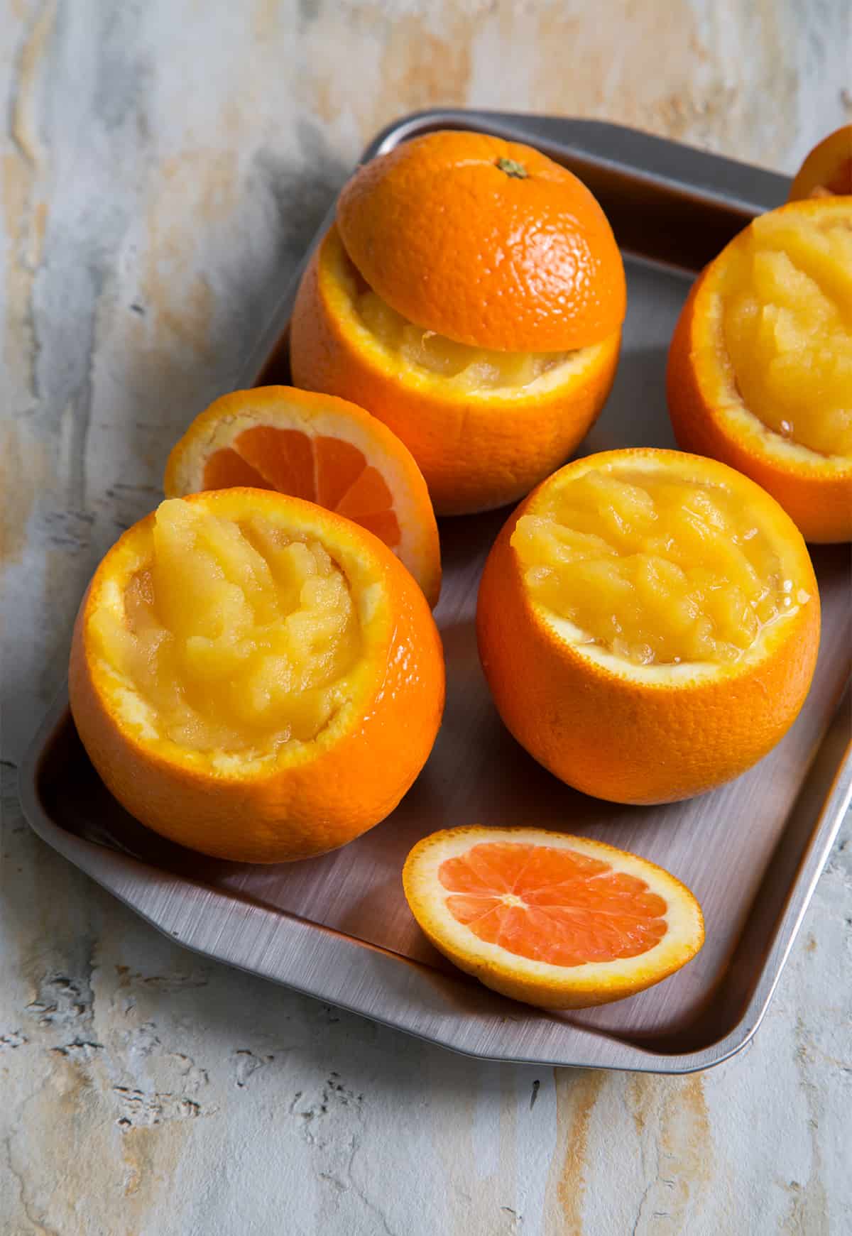 fresh churned orange sorbet in hallowed orange shells. 