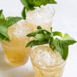 close up of three mint julep cocktails garnished with fresh mint